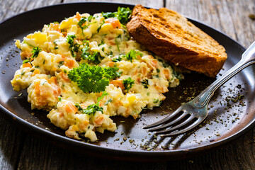 Vegetable mayonnaise salad with hard boiled eggs on white table
