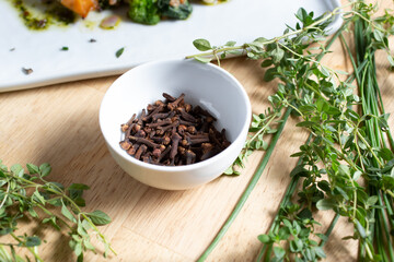 A view of a condiment cup of cloves.