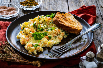 Vegetable mayonnaise salad with hard boiled eggs on white table
