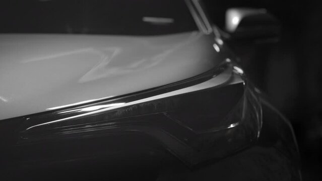 Driver start engine drive car with traffic turn on LED daylight headlight at night then turn on turning light before drive to vehicle to business at night
