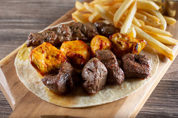 A view of a combination kebab platter, featuring chicken, beef and kofta.