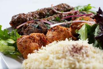 A view of a combo kabab plate of chicken, beef and kafta.