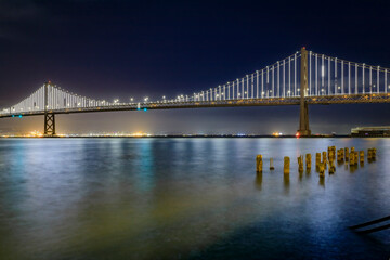 Fototapeta na wymiar San Francisco Bay Bridge lights the dey before they turn off on March 5th, 2023