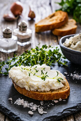 Cottage cheese sandwich with thyme on wooden table
