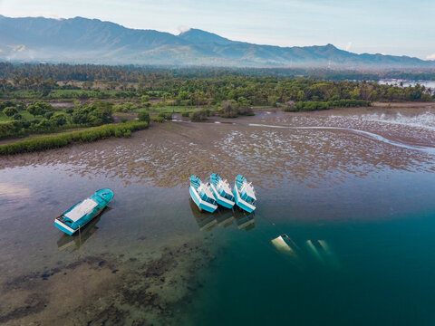 Aerial view of the boats in the ocean at low tide