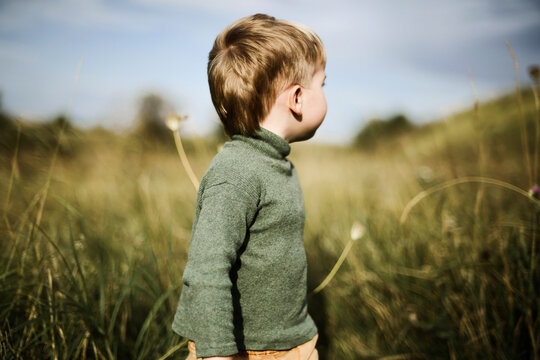 Portrait of a little pretty boy playing outside in the summertime
