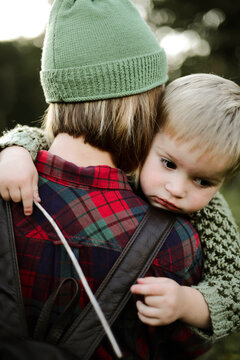 Mother holding her little adorable son overy her shoulder.