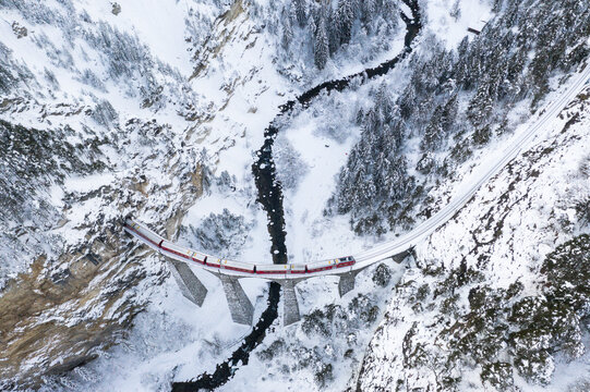 Aerial view of Bernina Express train in winter, Filisur, Switzerland