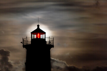 Harvest Moon behind lighthouse