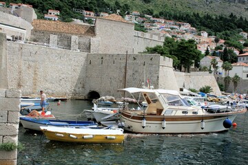 Fototapeta na wymiar boats and the wall of the old town Dubrovnik, Croatia