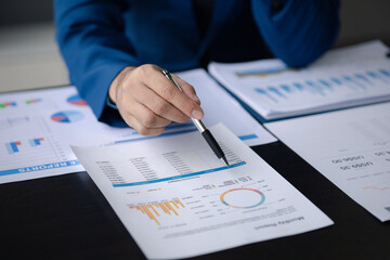 Business men are looking at the company's financial documents to analyze problems and find solutions before bringing the information to a meeting with a partner. Financial concept.