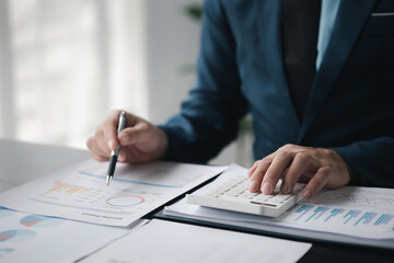 Business men are looking at the company's financial documents to analyze problems and find solutions before bringing the information to a meeting with a partner. Financial concept.