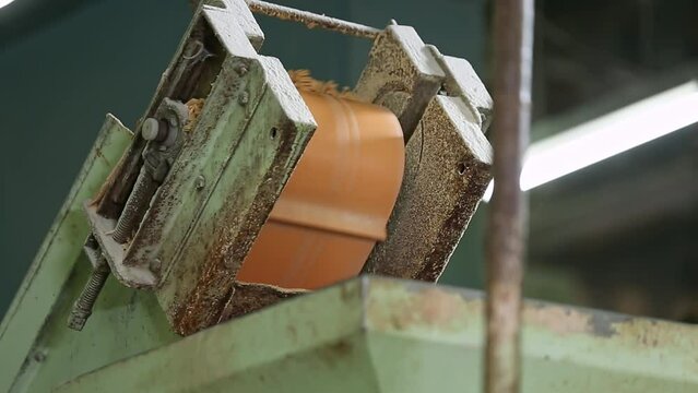 A closeup of raw soap material being dumped by conveyor belt