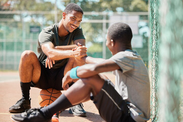Teamwork, sports and friends with black man on basketball court holding hands for support,...