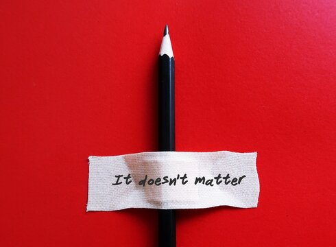 A pencil on red background with plaster band aid written IT DOESN'T MATTER,  to tell someone you are not upset at what they have done, don't worry or never mind
