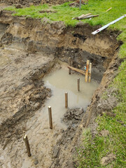 Flooded trench prepared for the construction of foundations.
