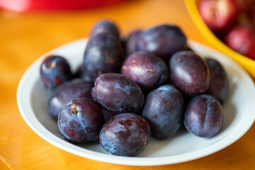 bowl of fruit, plums and apricot