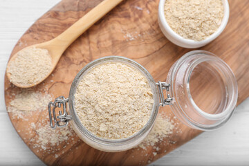 Beer yeast flakes on white wooden table, flat lay