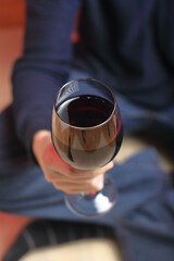 person holding a glass with wine