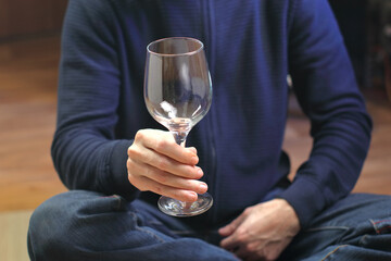 person holding an empty wine glass