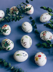 Easter eggs with floral ornament on blue table