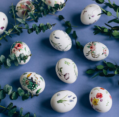 Easter eggs with floral ornament on blue table