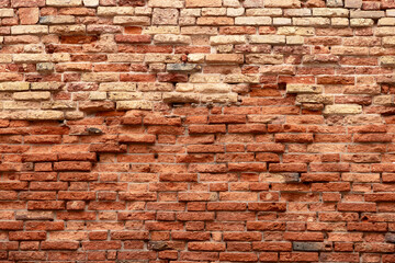 Weathered and sunburned old brick wall. High resolution photo with detail for background