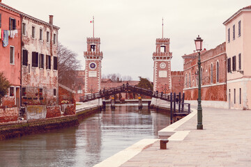 Canal of Venice leading to the Venetian arsenal with wooden bridge (Ponte de l'arsenal) Vintage style photo