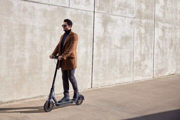 Handsome man commute to work on electric scooter
