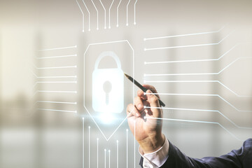Double exposure of male hand with pen working with virtual creative lock hologram with chip on blurred office background. Information security concept