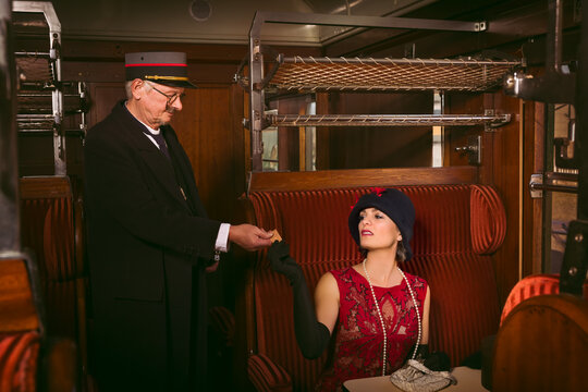 Vintage train conductor in old steam train