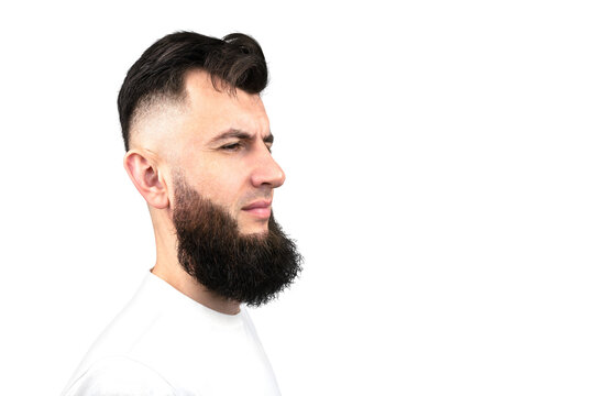 Portrait of a dark haired man with a stylish hairstyle and beard. Male profile isolated on white background. Care for a beard. Haircut