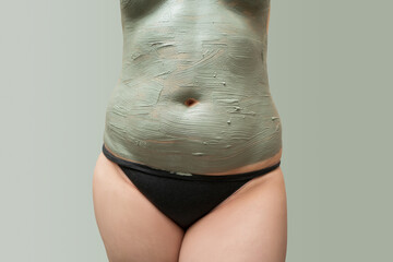 Mud spa procedure, woman applying cosmetic clay body mask, anti cellulite skincare concept