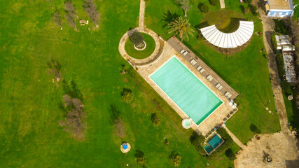 Aerial view of a rectangular swimming pool, belonging to a large villa. The pool is empty and no...