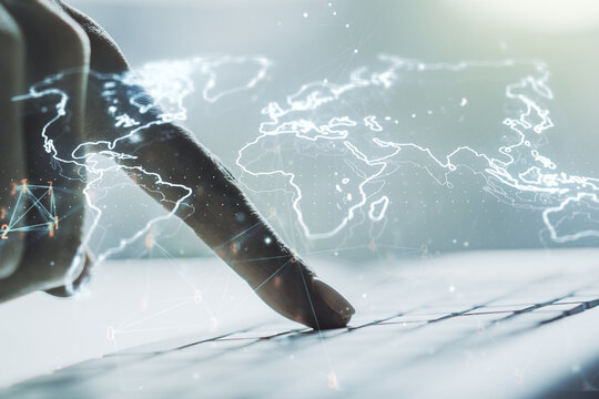 Double exposure of abstract digital world map and hand typing on laptop on background, big data and blockchain concept - Powered by Adobe