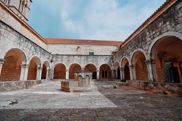 Fototapeta na wymiar Ancient catholic architecture. The courtyard of Franciscan Monastery in Hvar, Croatia.