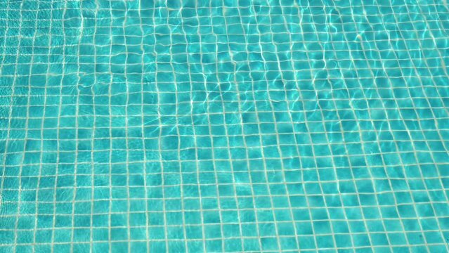 water wave slow motion on blue swimming pool, beautiful pool texture background