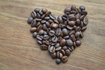 Roasted Brown Coffee Beans Heart Shape wooden Background