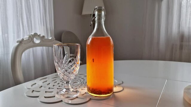 Opening a bottle of home made kombucha from the black tea. Second fermentation - fuzzy healthy drink