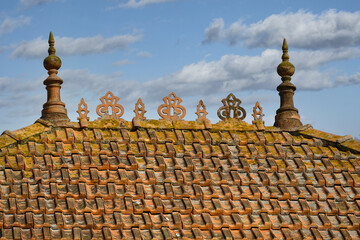 Fototapeta na wymiar Terracotta tiles, made from molded and baked clay cover the roof of a house in Murtosa, Portugal