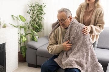 Head shot old male pensioner involved in rehabilitation procedure with caring young physiotherapist. retired man with walking disability feeling thankful for professional help.