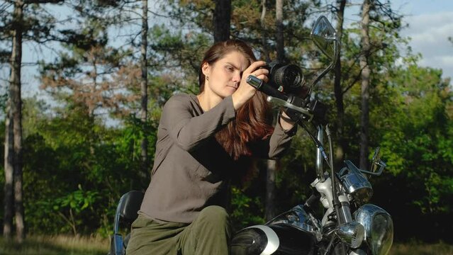 Young Woman Taking A Photo While Sitting On A Motorcycle