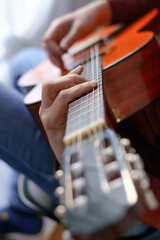 man's hands playing the Spanish guitar