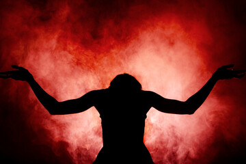 Silhouette modern ballet dancer. Ballerina posing against black with smoke in the background © Nikola Spasenoski