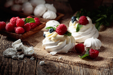 Dessert Pavlova with raspberries, blueberries and mint.