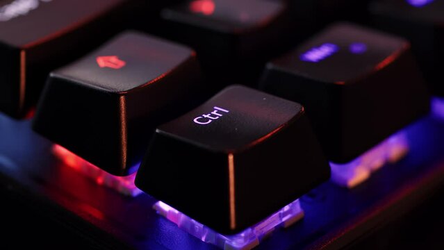 Human finger is clicking on the Ctrl button on the computer keyboard, close up view. The finger presses Ctrl on the keyboard key, macro shot. Loop footage.