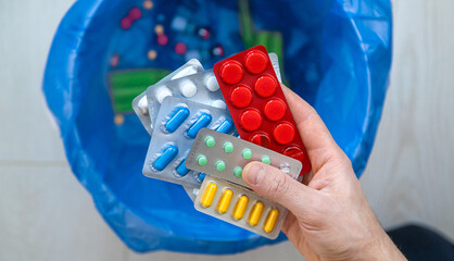 Throw tablets in the trash. Selective focus.