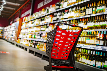 A shopping cart with grocery products in a supermarket