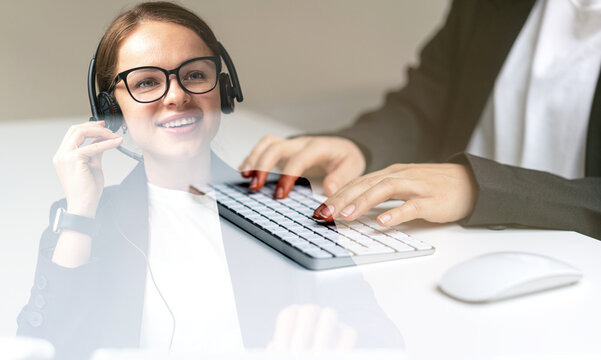 Woman contact center agent talking with customer using headset.