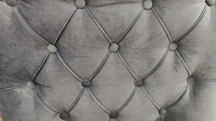 Grey capitone checkered soft fabric textile decorative background with buttons. Classic retro Chesterfield style, luxurious upholstery buttoned texture for furniture, wall, headboard, sofa, couch